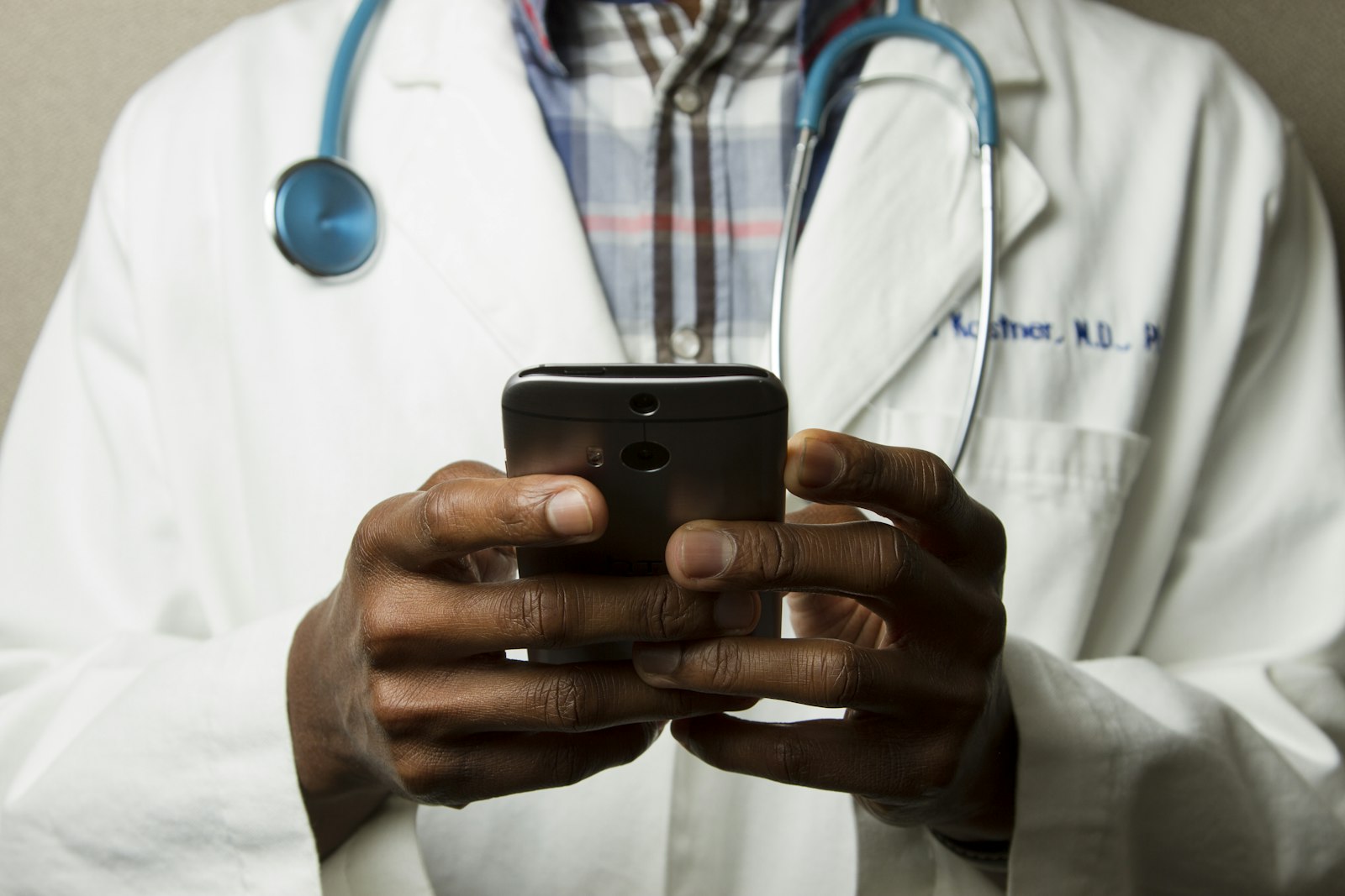 A doctor using a phone between consultations